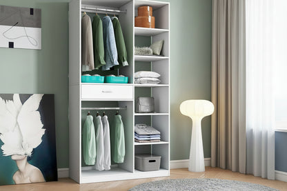 White wardrobe with clothes and shelves in a room with a gray wall and a lamp.